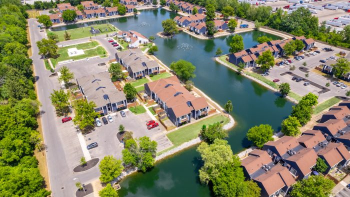 aerial view of a residential neighborhood with a lake at The Lakeshore Cove