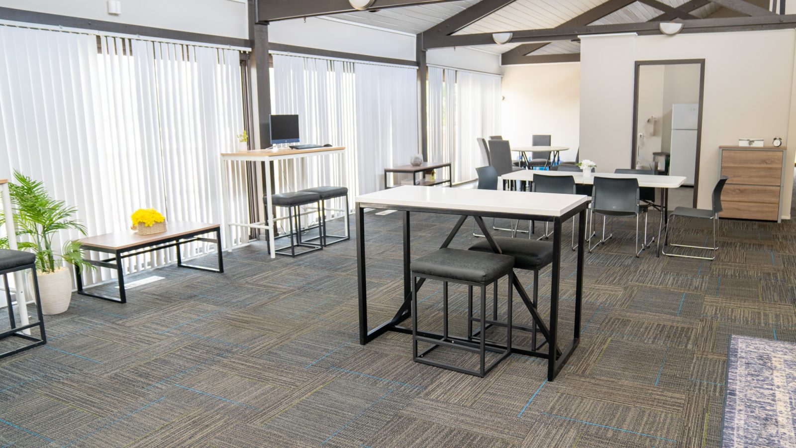 a large open office with tables and chairs at The Lakeshore Cove