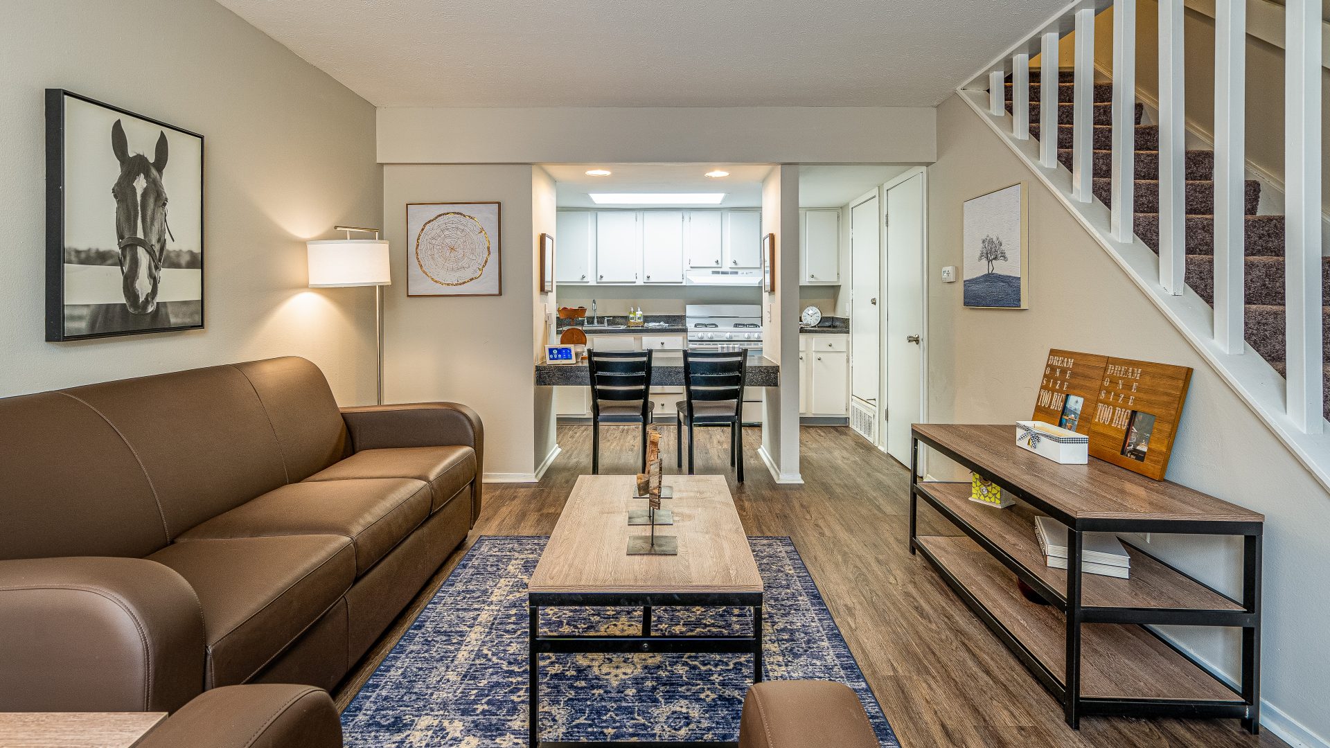 a living room with brown couches and a coffee table at The Lakeshore Cove