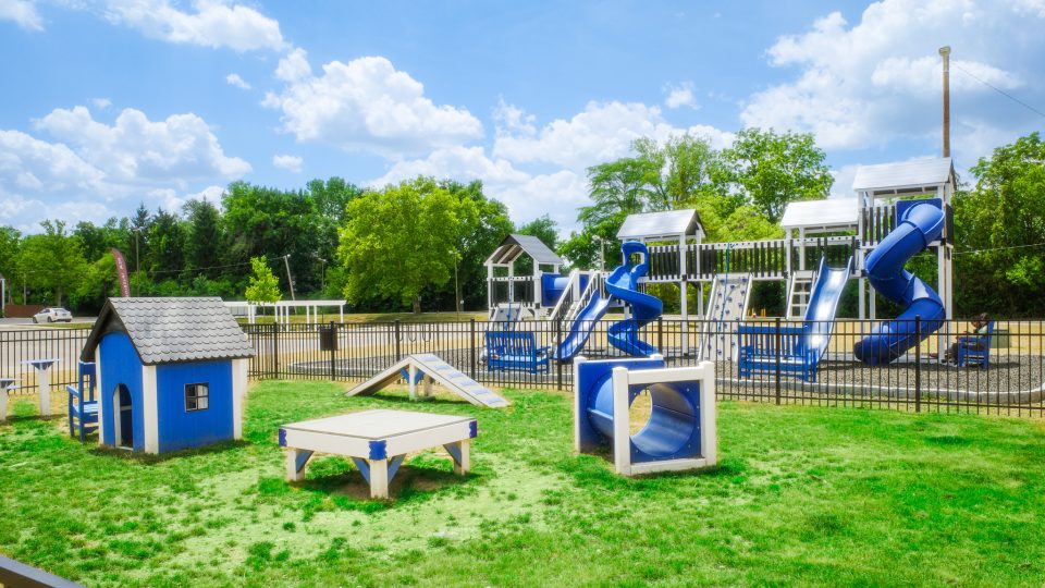 a playground with a slide and a blue slide at The Lakeshore Cove